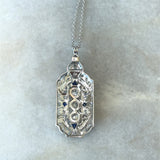 Vintage 1930's pendant with 1CT old European-cut diamonds and blue sapphire accents in 18KT white gold filigree KFK Jewelers Los Angeles 