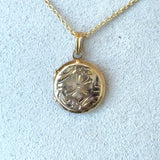 Vintage 1950s 10KT yellow gold round locket with floral design KFK Jewelers Los Angeles