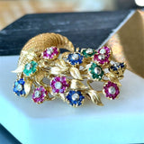 Vintage Tiffany & Co. 18K yellow gold cornucopia brooch pin with flowers "en tremblant" crafted in sapphires, emeralds, and rubies with a diamond center KFK Jewelers Los Angeles